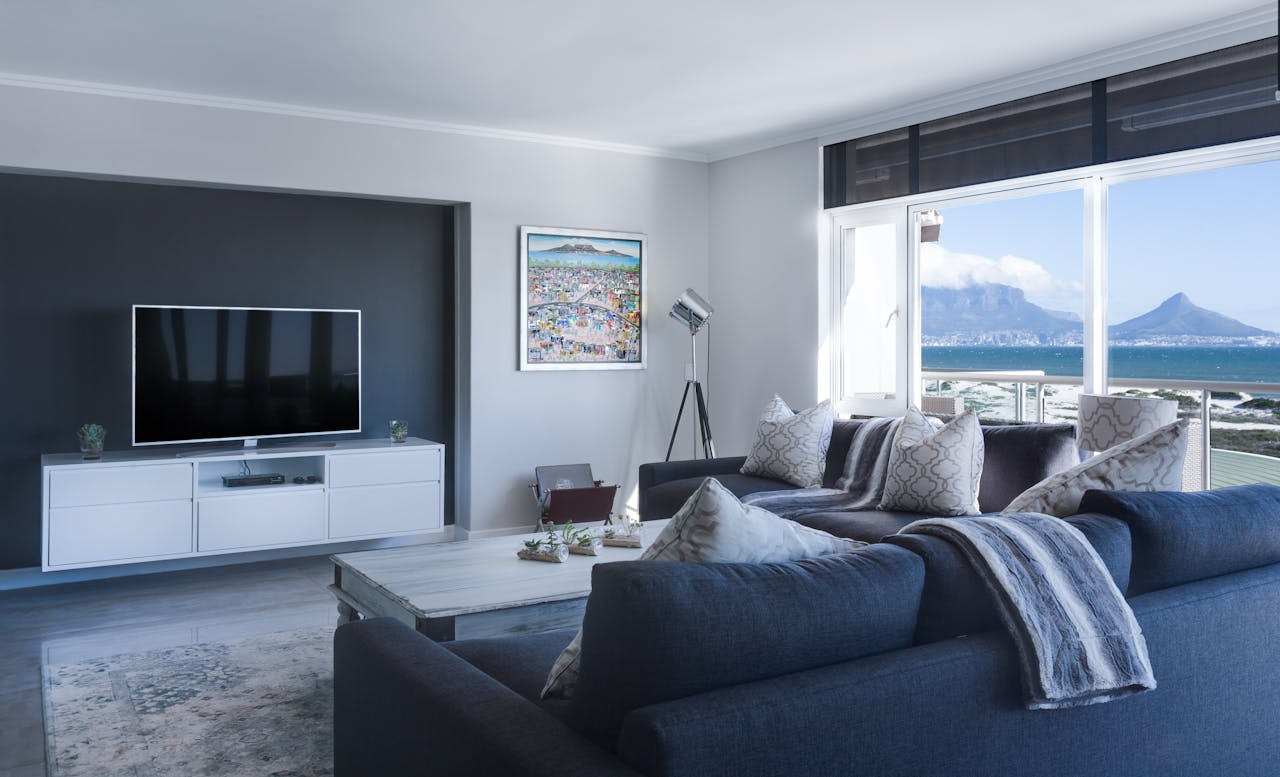 The Art of Drawing Readers In: Your attractive post title goes here Stylish living room with a view of Table Mountain, blending modern design with natural beauty.